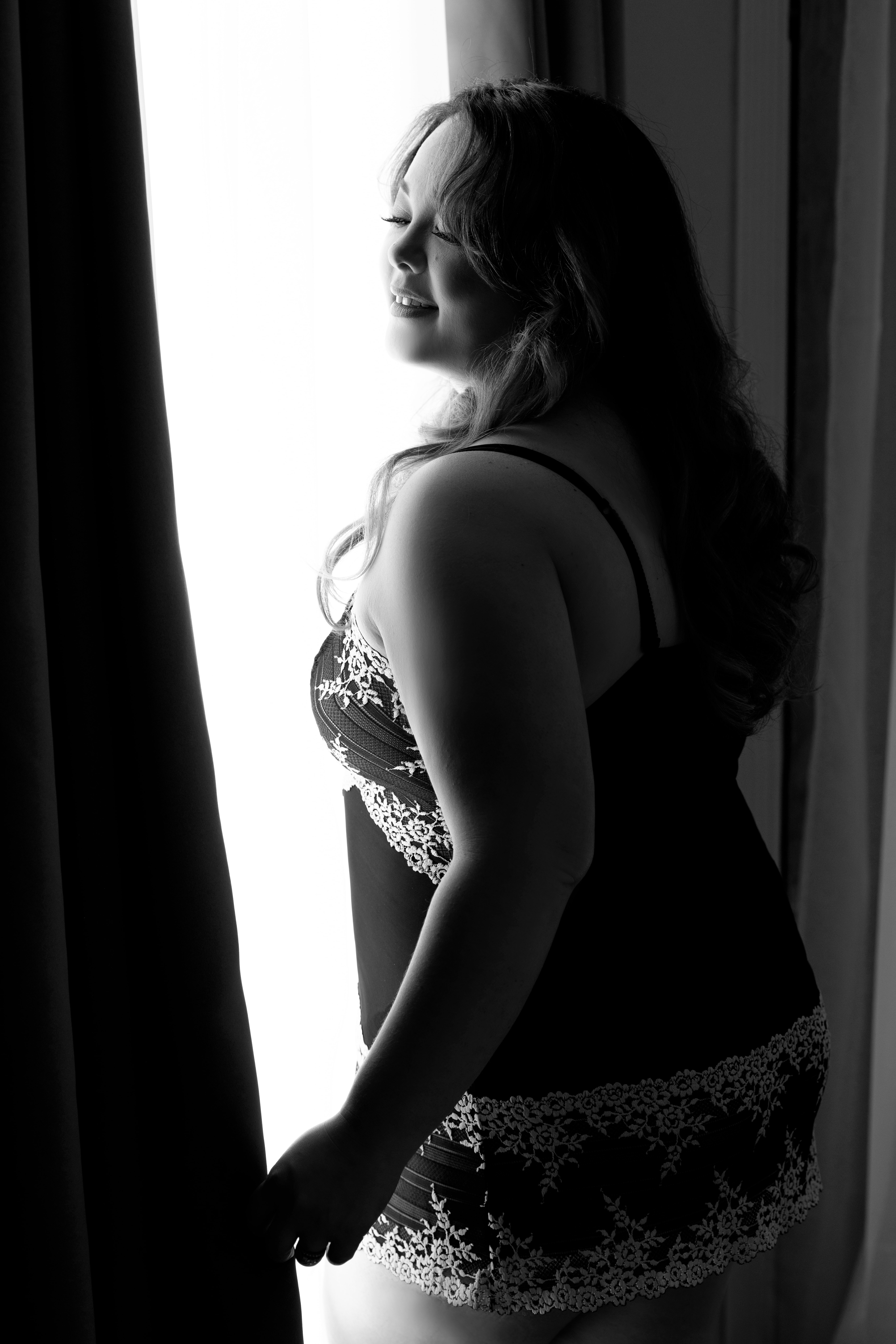 Woman wearing a black and white nightie for a boudoir session with Shannon Hemauer Photography. 