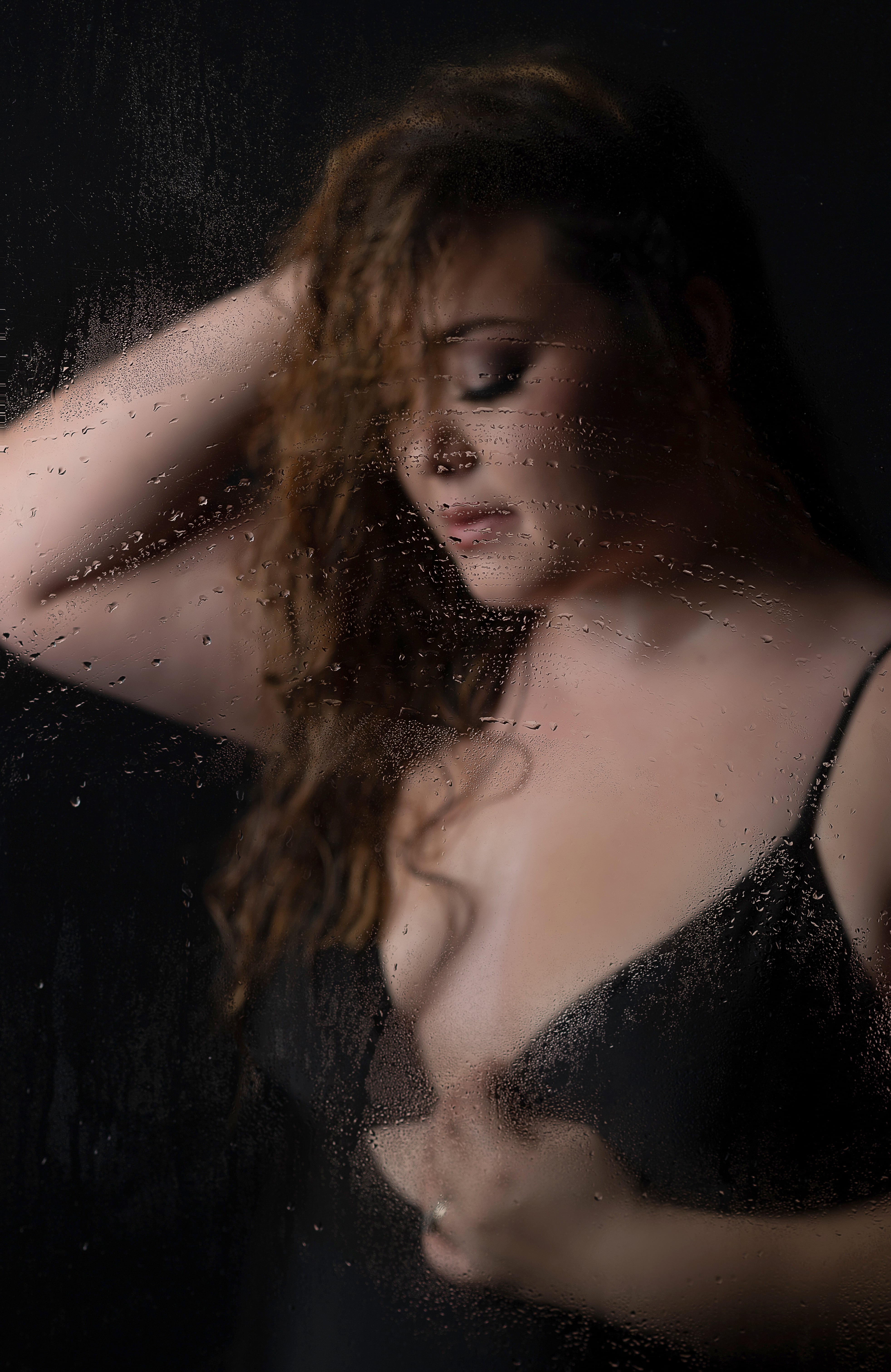 Woman wearing a black bathing suit for a boudoir shower session with Shannon Hemauer Photography.