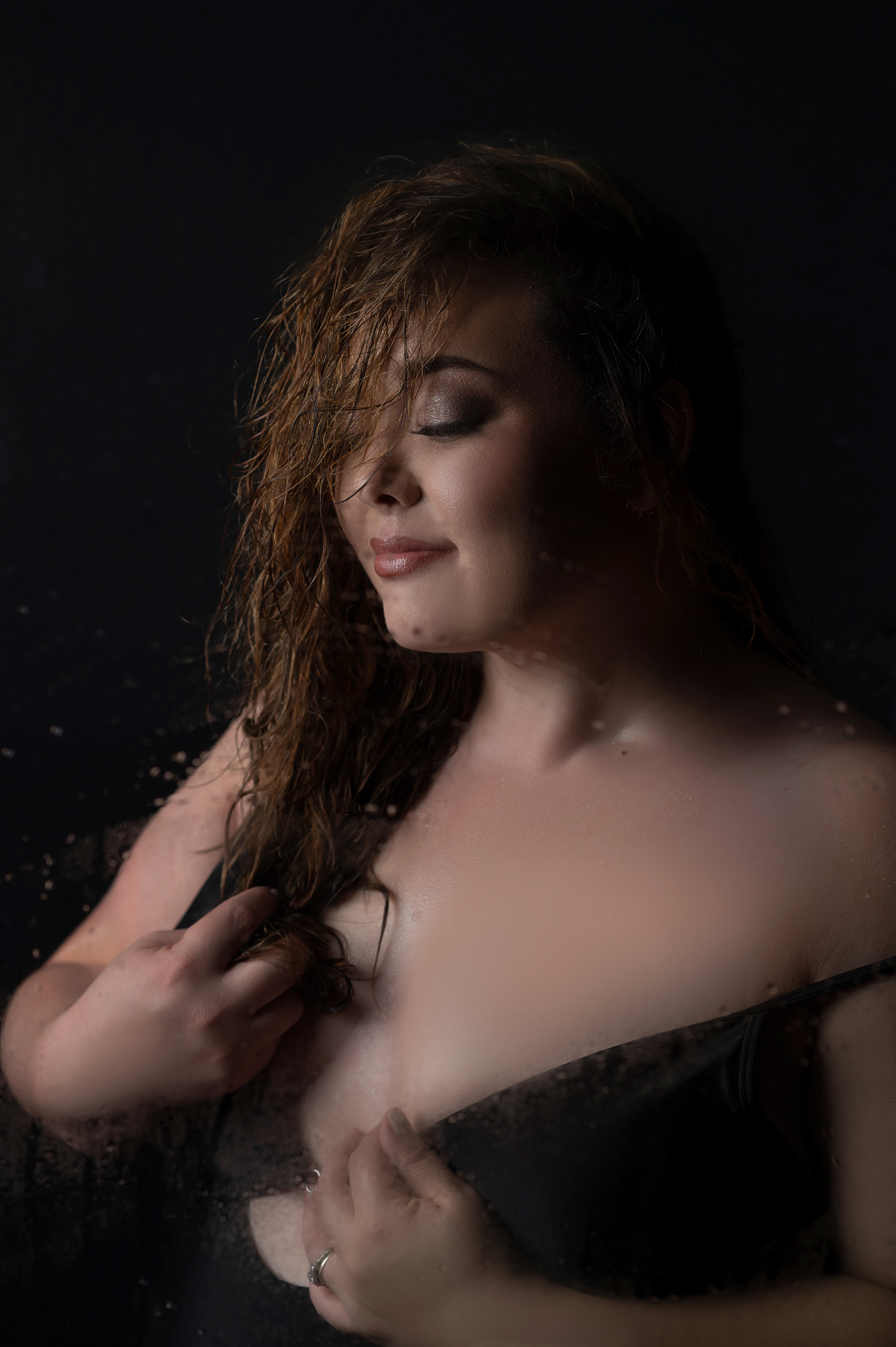 Woman wearing a black bathing suit for a boudoir shower session with Shannon Hemauer Photography. 
