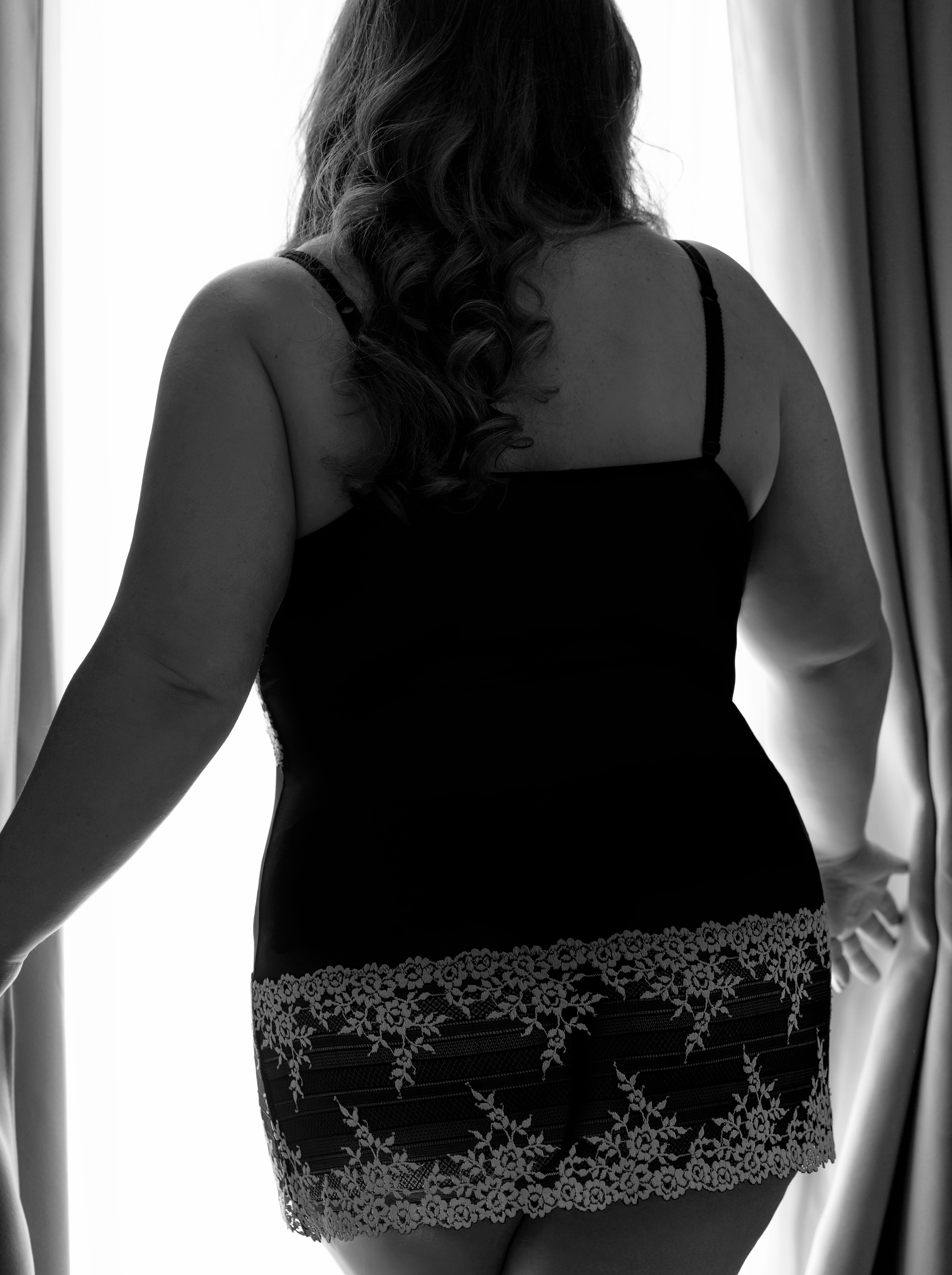 Woman wearing a black and white nightie for a boudoir session with Shannon Hemauer Photography.